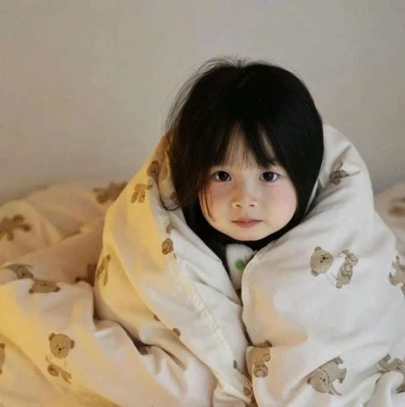 Bé gái quấn chăn họa tiết gấu